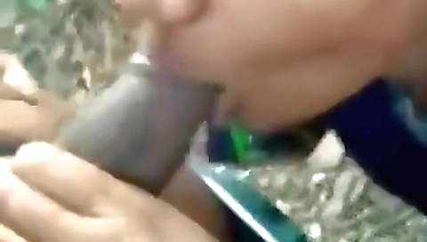Indian deepthroat sex in a leather suit in the field
