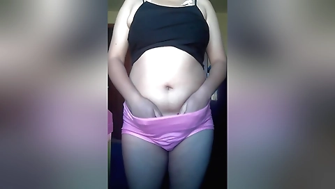 Chubby brunette masturbates on the bed on the floor
